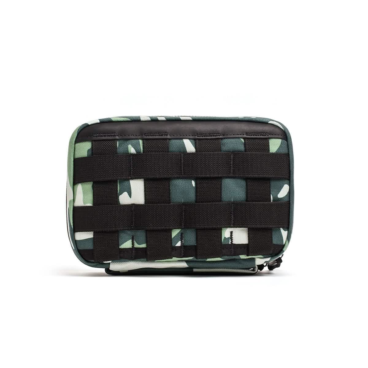 The GR1 Field Pocket x Gear Patrol by GORUCK showcases a Variegated Elephant Ear Camo pattern complemented by black horizontal webbing on the front. This durable pouch, with its zipper closure, offers a tactical design ideal for Gear Patrol fans.