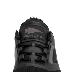 Close-up of black GORUCK rucking shoe with logo patch and durable laces detail