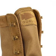 Close-up of a coyote MACV-2 High Top by GORUCK, highlighting the intricate stitching and logo label on the tongue. The boot includes metal eyelets, a sturdy triple compound outsole, and tough materials crafted to endure any challenge.