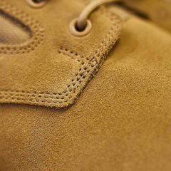 Close-up of the MACV-1 Hi-Speed - High Top by GORUCK, highlighting the detailed stitching near the laces reminiscent of lightweight rucking boots. The texture of the brown suede material and eyelets is prominently visible.