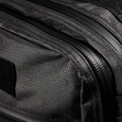 Close-up of the GR2 USA x Carryology - Ultra Black backpack, showcasing its textured UHMWPE fabric, zippers, and Velcro patch.