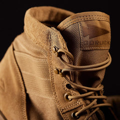 Close-up of tan GORUCK tactical rucking boot with durable suede and nylon upper against black background