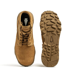 A pair of MACV-2 - Mid Top - Coyote boots from GORUCK is displayed against a white background. One boot is shown from the side, while the other features its rugged tread pattern by highlighting the MACV-2's triple compound outsole. The laced-up boots exude a sturdy and durable appearance.