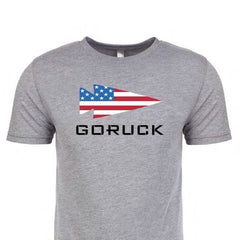 The "T-shirt - GORUCK USA - Grey" features a tri-blend material with an arrow design showcasing the U.S. flag and bold "GORUCK" text, honoring Special Forces.