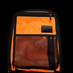 Open black GR2 USA x Carryology – Ultra Black backpack with bright orange interior, mesh pocket, and a visible ULTRA GR2 label, crafted from durable Challenge Sailcloth.
