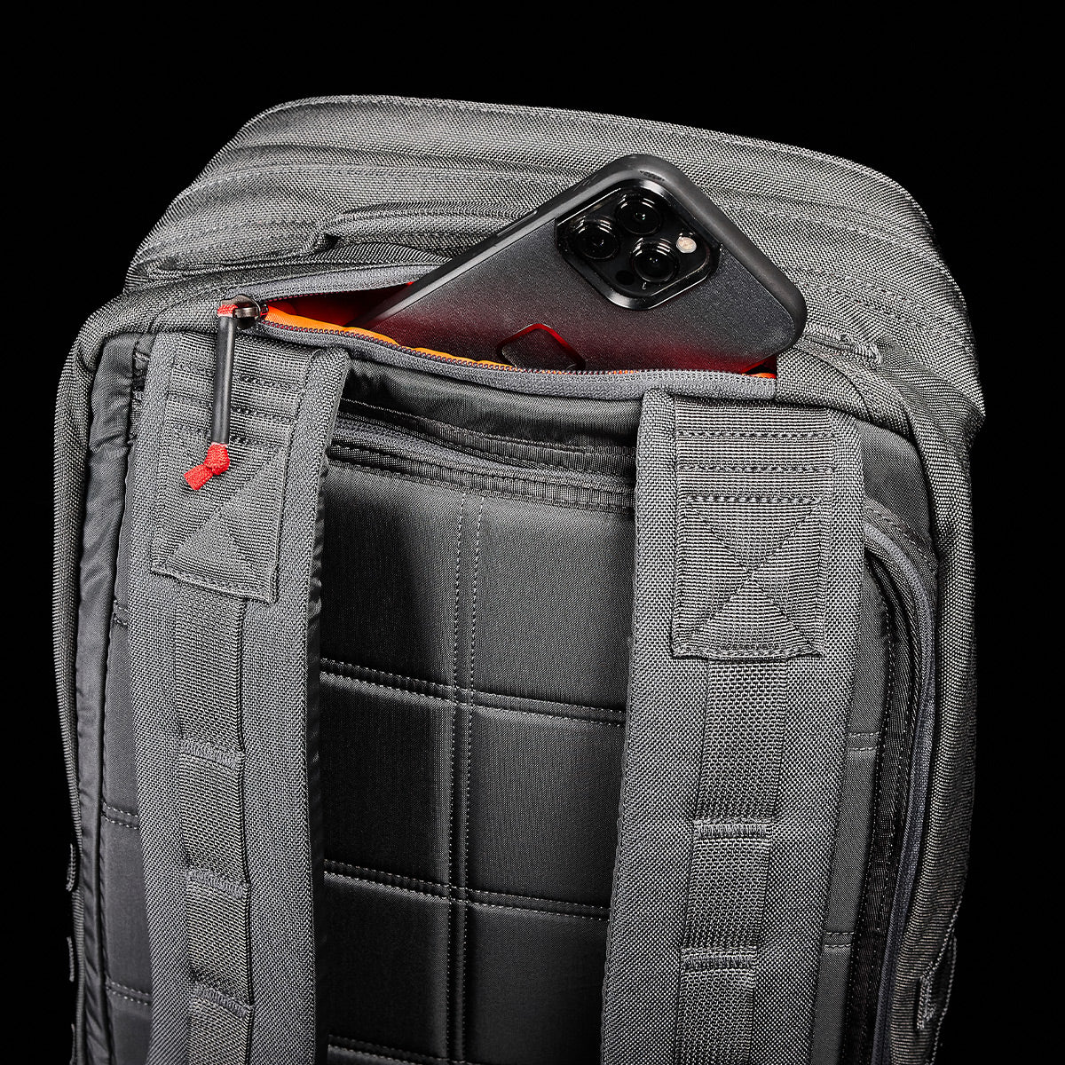 The GR2 - Ballistic Nylon Cordura rucksack in black features a zippered pocket behind the shoulder straps for your phone—perfect as a carry-on travel bag.