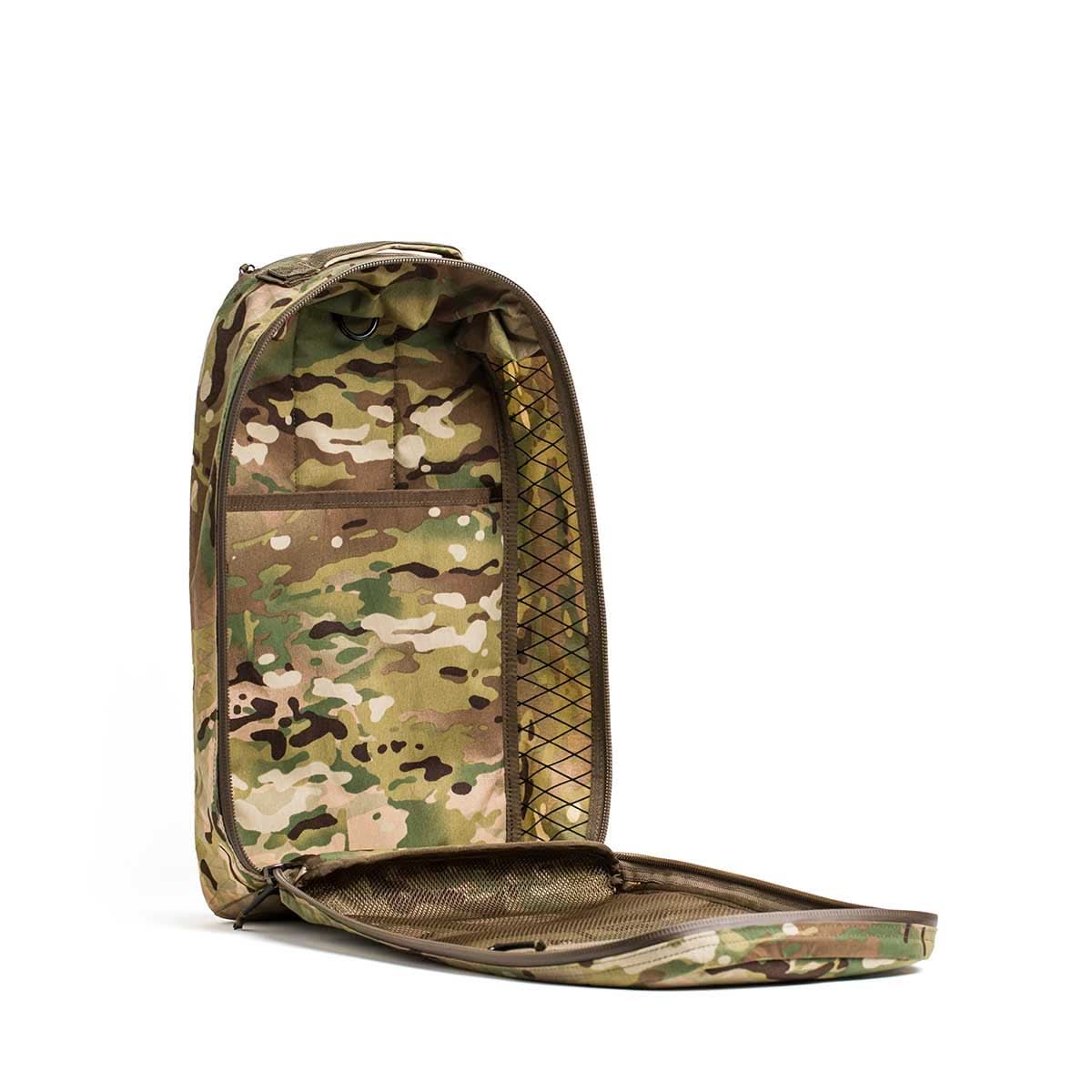 The Bullet X-PAC daypack, featuring a camouflage pattern, is open to show an empty main compartment with inner mesh pockets and tough AquaGuard zippers.