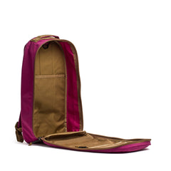 The Bullet Ruck Classic - Ballistic Nylon Cordura backpack in magenta and brown is unzipped, showing off its spacious tan interior compartments.