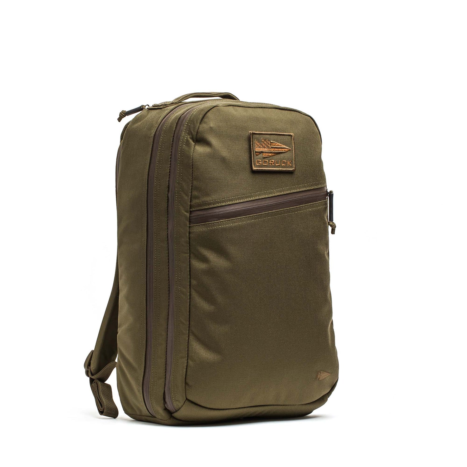 The Double Compartment Bullet Ruck - Ballistic Nylon Cordura - 18L in olive green features a leather patch, double compartment ruck design, front zip pocket, and top handle, shown upright against a white background.