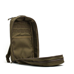 The Double Compartment Bullet Ruck - Ballistic Nylon Cordura - 18L in olive green features a bombproof laptop compartment and an unzipped main section revealing organized interior pockets.