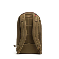 The Double Compartment Bullet Ruck - Heritage Waxed Canvas - 18L is shown from the back with padded straps and back panel against a white background—an ideal everyday travel daypack.