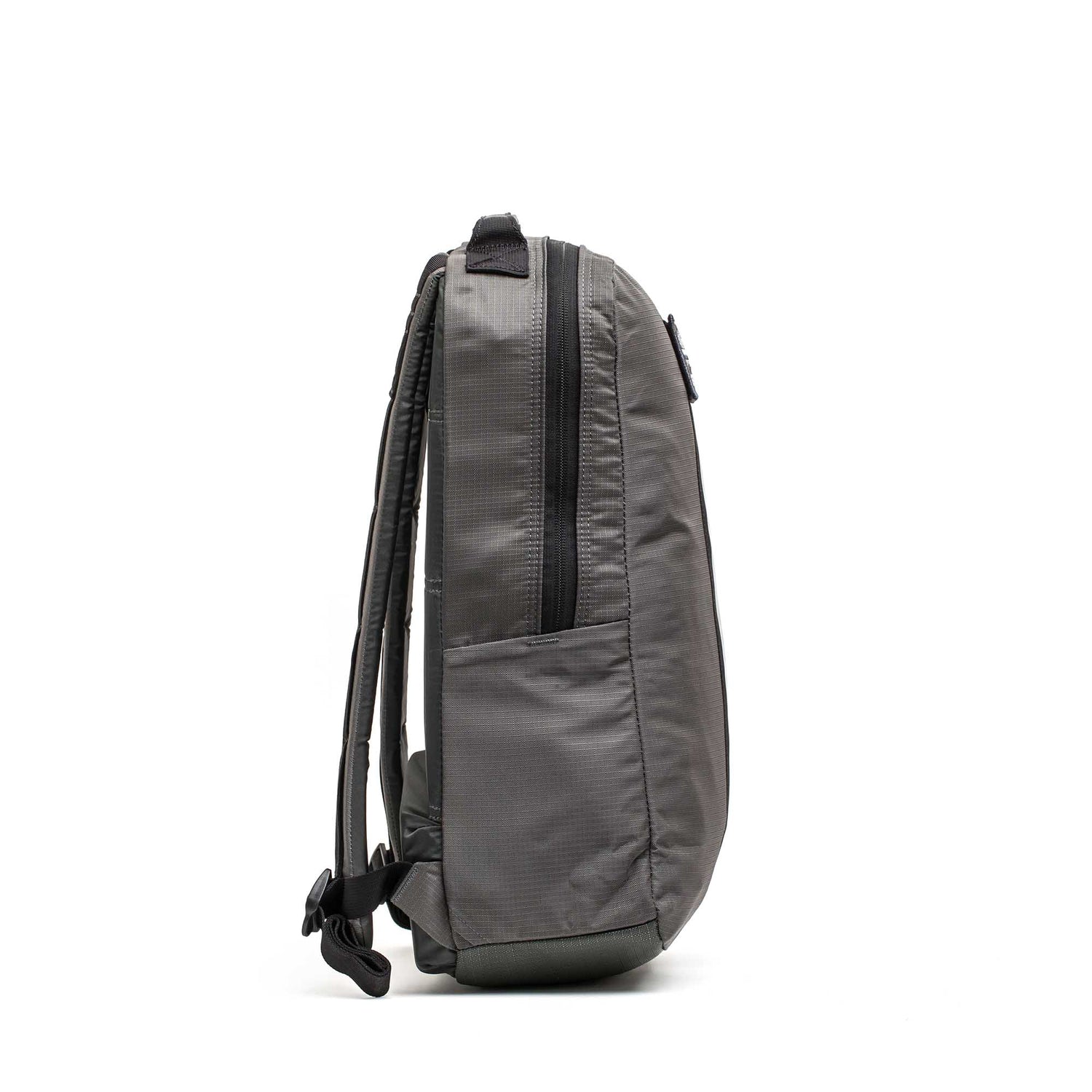 Side view of the Basic Rucker in gray with black straps and a zipper, designed for rucking, standing upright on a white background.