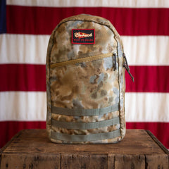 Arid Bullet - Built by Scars in camouflage on wood, set against a limited edition flag backdrop.