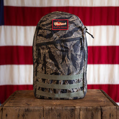 Tiger Stripe Robic Bullet - Built by Scars ruck on crate with American flag in Jax Beach, Florida.