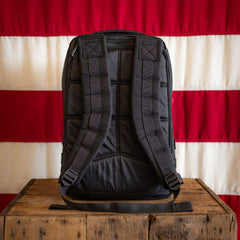 Fireworks GR1 21L - Built by Scars with padded straps sits on a wooden box against a striped background.