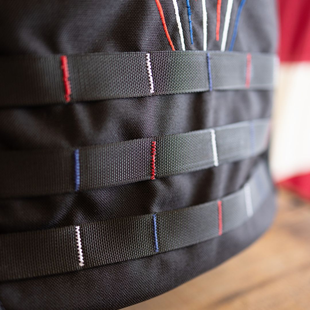 Close-up of Fireworks GR1 21L - Built by Scars Cordura with horizontal straps and colored thread accents.