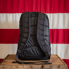 The Join or DIE GR1 21L - Built by Scars sits on a wooden table before a red and white striped flag.