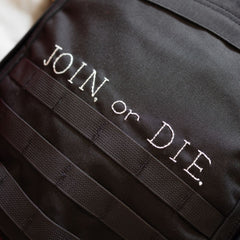 Black bombproof Cordura with white “JOIN, or DIE.” text on the Join or DIE GR1 21L - Built by Scars.