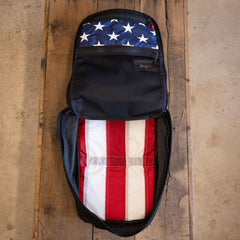 Join or DIE GR1 21L - Built by Scars: American-made, flag-lined Cordura backpack sits on wood.