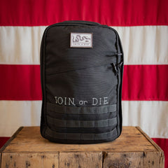 The JOIN, or DIE GR1 21L - Built by Scars rests on a wooden box with a red and white flag in the background.