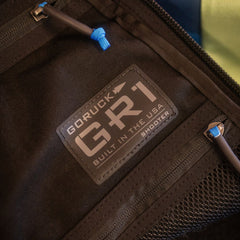 Close-up of a limited edition Shooter 26L Mosaic - Built by Scars patch with visible zippers.