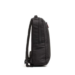 The Basic Rucker backpack in black is displayed from the side against a white background, highlighting its zipper and shoulder straps—ideal for rucking and compatible with any standard ruck plate.