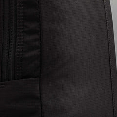 Close-up of a black fabric Basic Rucker backpack, featuring a visible zipper and textured material—perfectly suited for rucking or pairing with your favorite ruck plate.