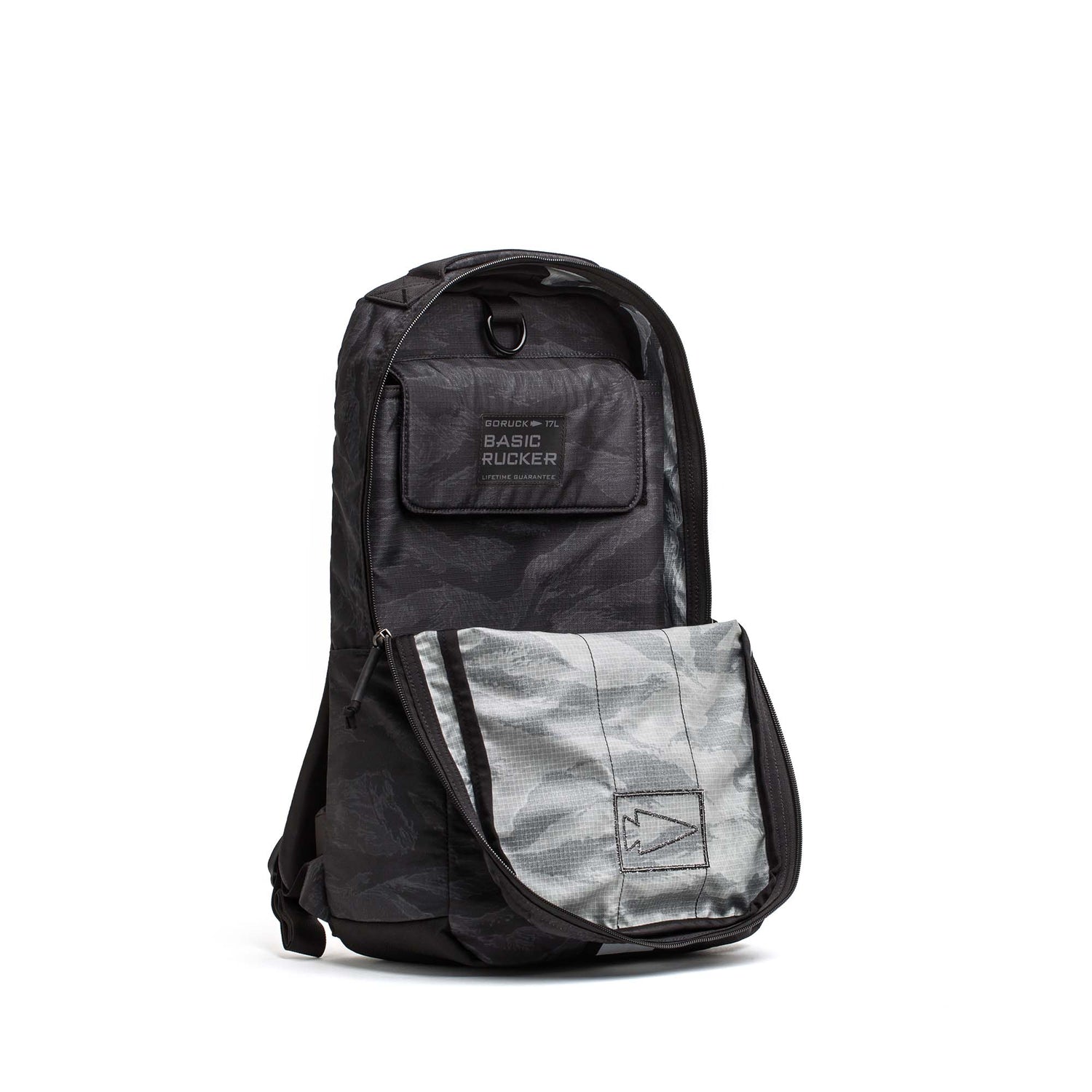The Basic Rucker is a black and gray camo GORUCK rucking backpack featuring a front pocket and a 