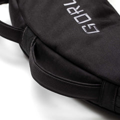 Close-up of a black Bulgarian Sandbag with stitched handles and partial white embroidered text.