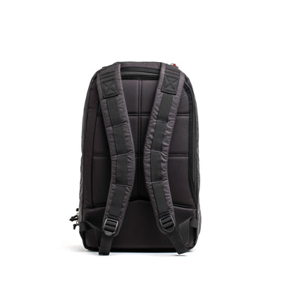 The GORUCK Bullet Ruck Double Compartment - Dyneema is showcased in black with durable construction. Featuring padded, adjustable shoulder straps and a quilted back panel for enhanced comfort, its practical design includes zippers and side pockets ideal for everyday use. This backpack also offers the added benefit of a lifetime guarantee.