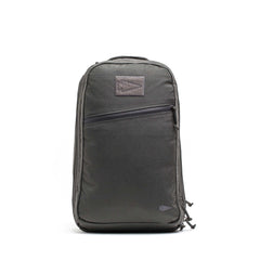 The Double Compartment Bullet Ruck - Ballistic Nylon Cordura - 18L is a sleek black travel backpack featuring a bombproof laptop compartment and front zipper pocket, displayed standing upright against a white background.