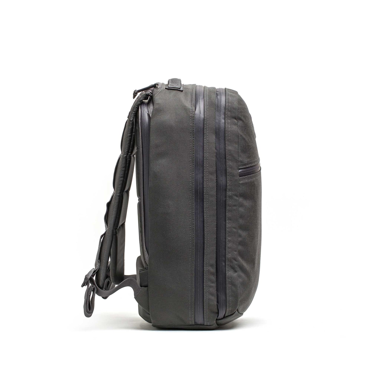 The Double Compartment Bullet Ruck - Ballistic Nylon Cordura - 18L is shown from the side on a white background, highlighting its zippers, straps, sleek design, and ultra-durable laptop compartment.