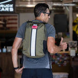 Man wearing sunglasses and a gray shirt, giving a thumbs up, carrying the Basic Rucker—ready for some serious rucking.