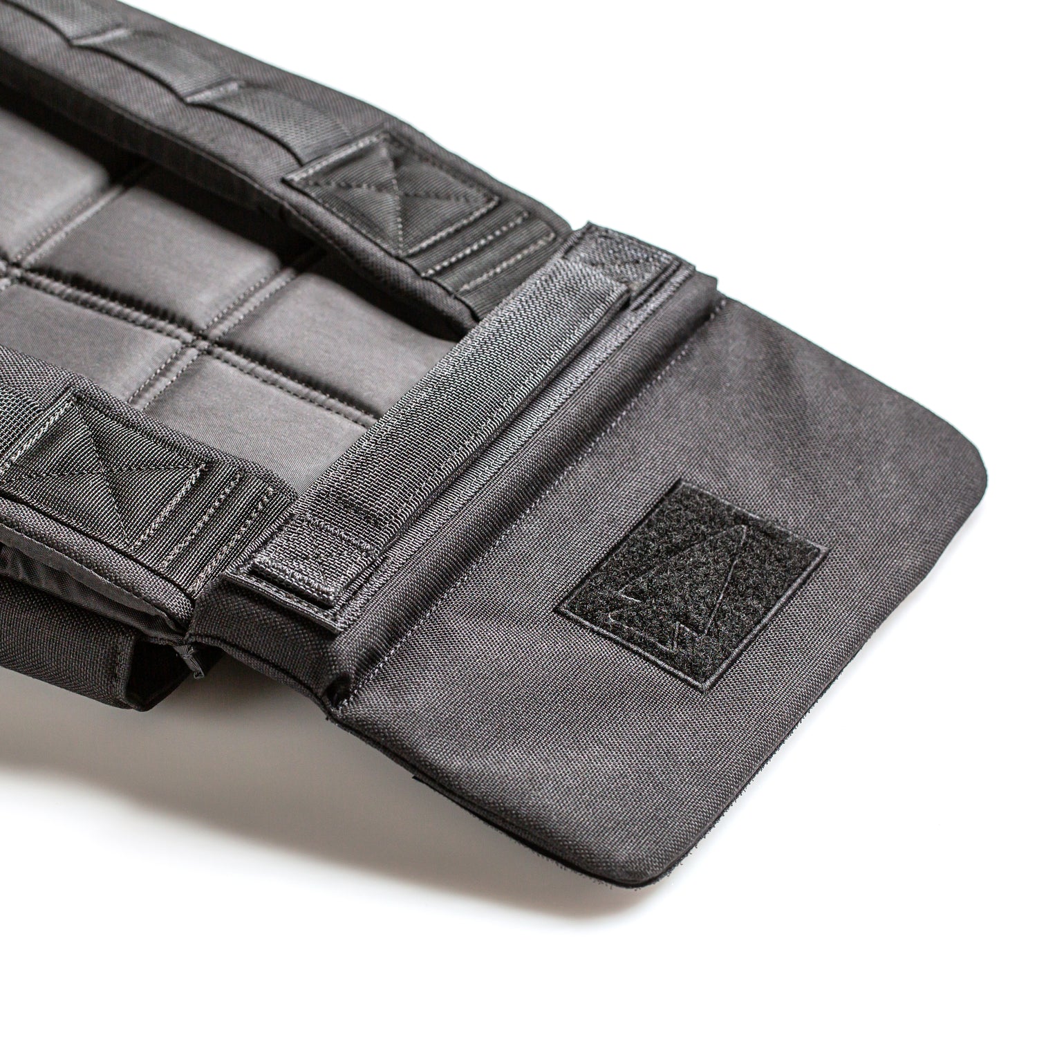 Close-up of a black padded strap with Velcro fasteners and reinforced stitching, designed for the RPC Long + 30LB (Long) Plate Bundle to provide ergonomic lumbar support, shown on a white background.