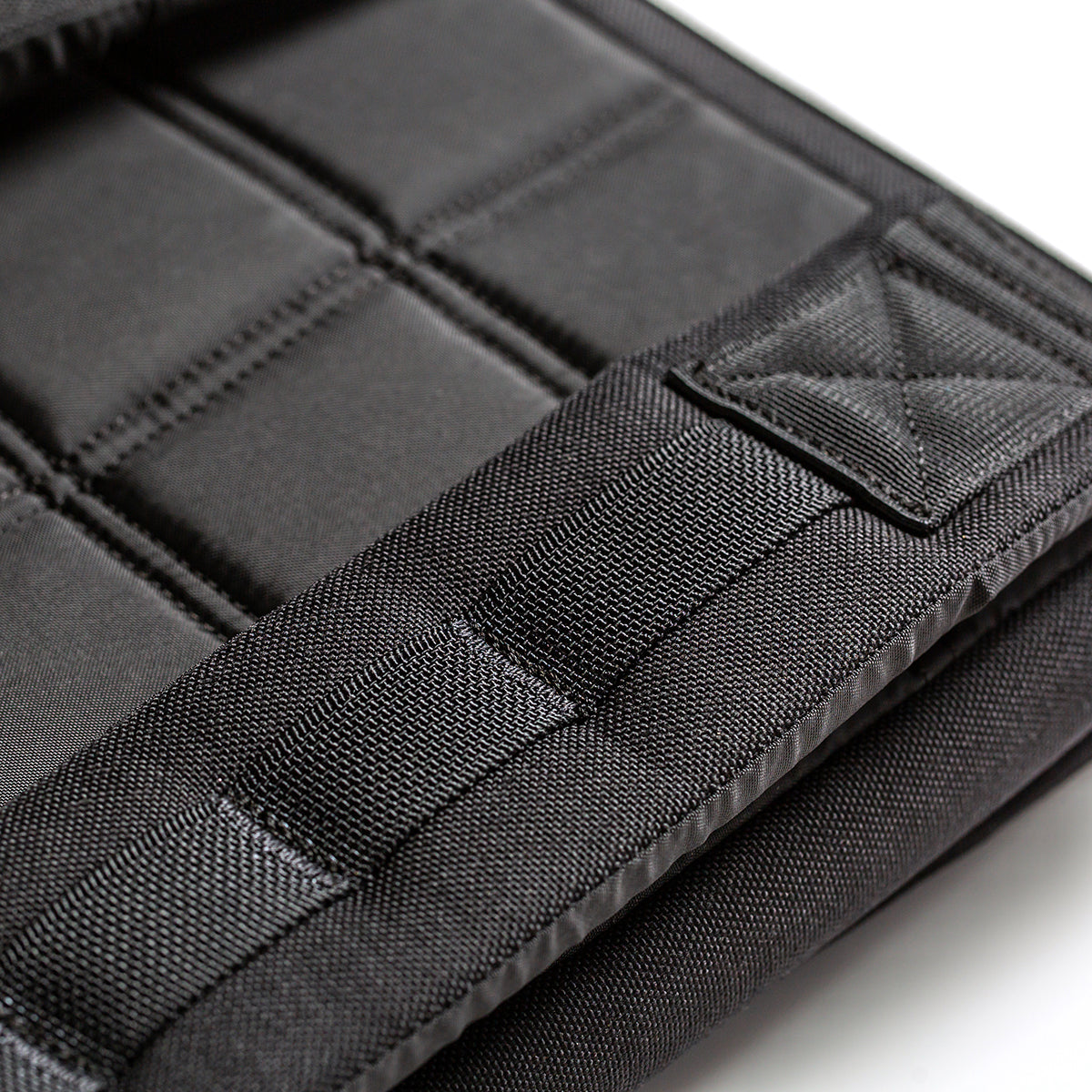 Close-up of the black padded fabric with square and rectangular stitching on the RPC Long + 30LB (Long) Plate Bundle—weight vest designed for ergonomic lumbar support.