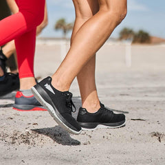 People rucking on sand wearing GORUCK black and grey athletic shoes outdoors