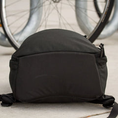 GORUCK black rucksack on pavement with bicycle wheels in background, durable rucking gear