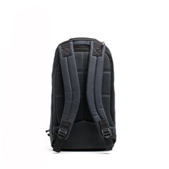 GORUCK black waxed canvas backpack with padded straps and laptop compartment, rear view