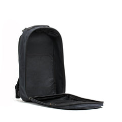Open black waxed canvas GORUCK backpack with single compartment and laptop compartment, showing inside storage pocket