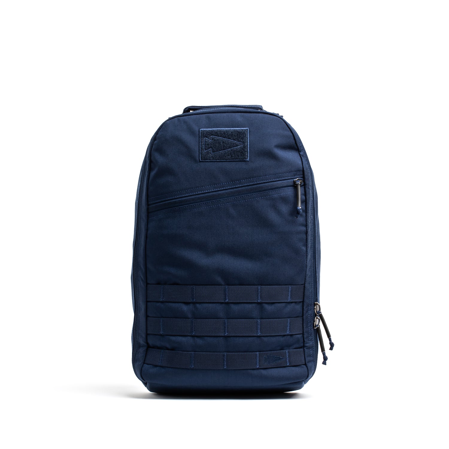 The Bullet Ruck Classic - Ballistic Nylon Cordura is a navy blue 15L daypack with a zippered front pocket and lower front webbing—ideal for everyday adventures.