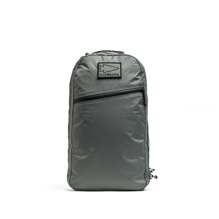 The Bullet X-PAC daypack in gray, shown upright on a white background, features a front AquaGuard zipper pocket.