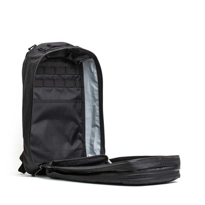 The Double Compartment Bullet Ruck - XPAC features a black design with unzipped main section, multiple internal pockets, sections, and a bombproof laptop compartment—perfect as a travel backpack.