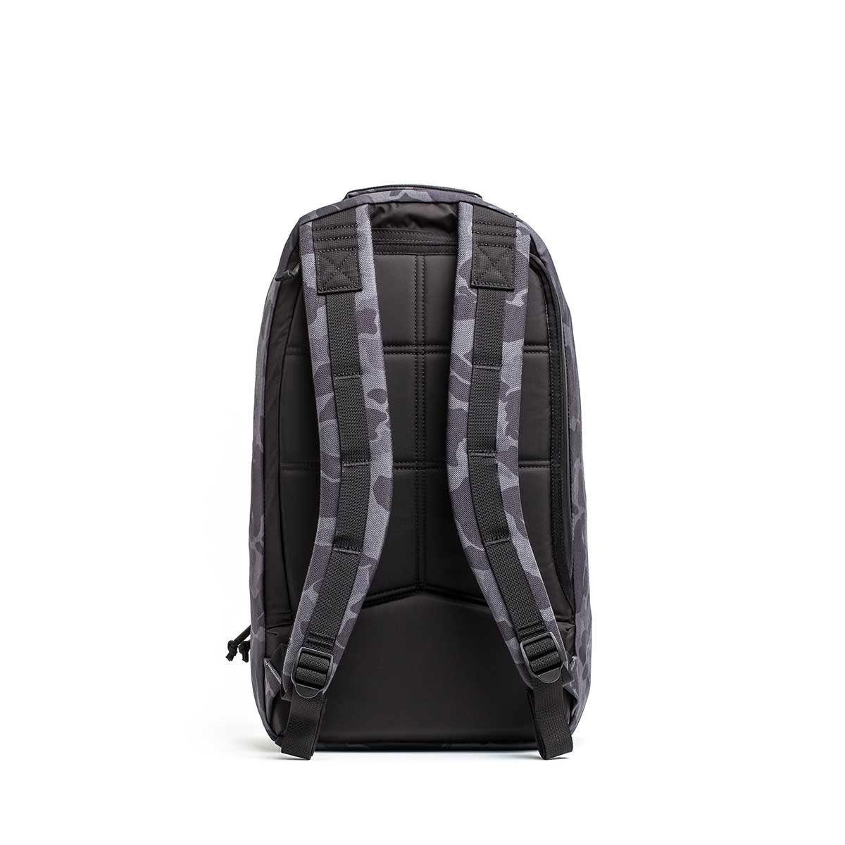 The Double Compartment Bullet Ruck - Ballistic Nylon Cordura - 18L is shown from the back in black and grey camo, highlighting its padded shoulder straps and back panel for comfort.