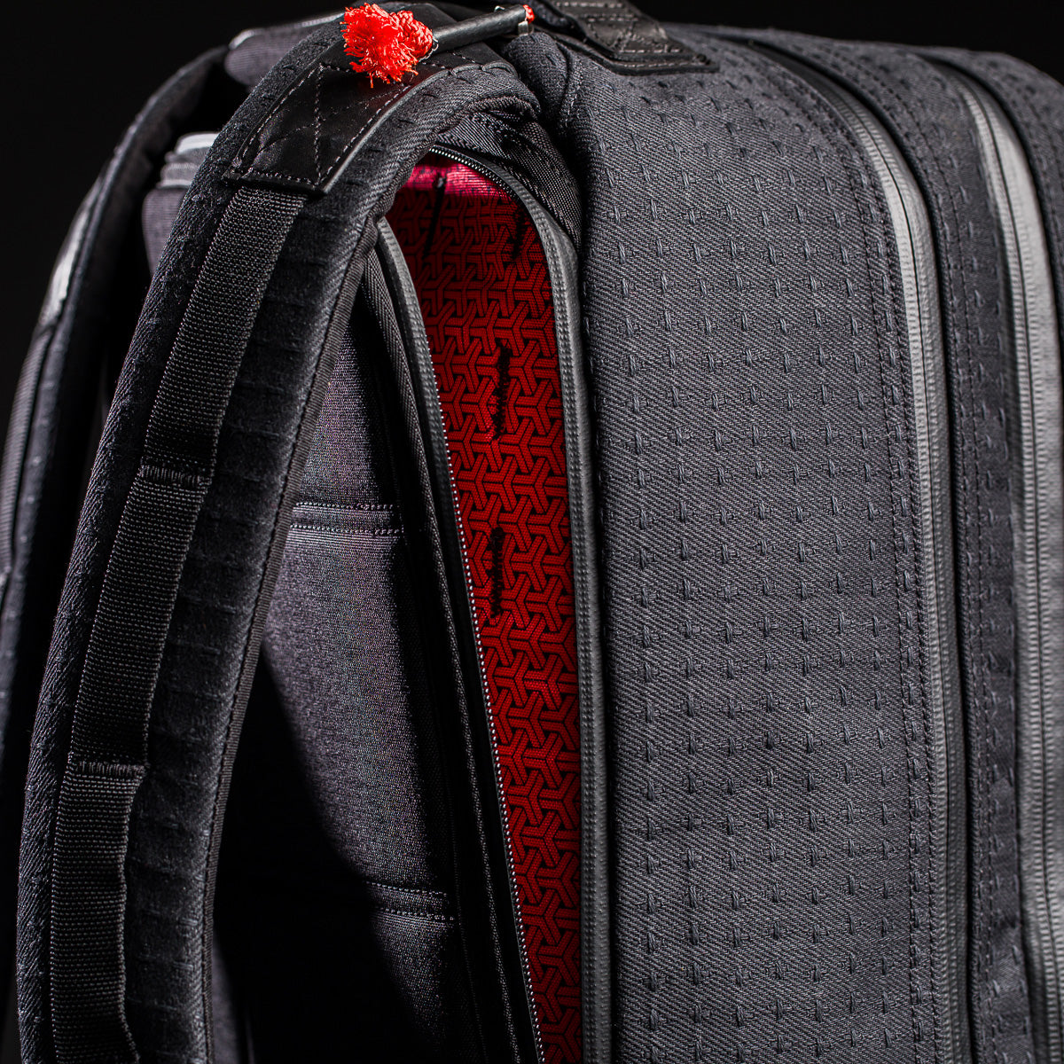Close-up of the limited-edition Bullet Ruck x Carryology - GRXC2 Samurai 2.0 backpack, featuring a red patterned interior inspired by JPXDP 17oz Black Samurai Sashiko and padded straps for comfort.