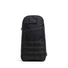 The Bullet Ruck USA Throwback is a black tactical daypack made with durable CORDURA fabric, featuring MOLLE webbing, a front zipper pocket, and a patch, displayed on a plain white background.