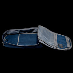 Open Bullet Ruck Classic - Cordura in blue, showcasing its streamlined design and multiple inner compartments against a black backdrop.