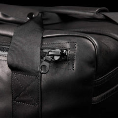 Close-up of GORUCK black kit bag with durable strap and rugged zipper detail