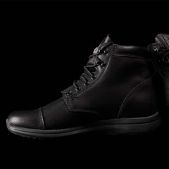 Black tactical GORUCK boots with sturdy leather and a durable sole on black background