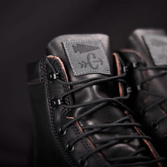 Close-up of black GORUCK boots with detailed stitching and logo patch on tongue, rugged rucking gear