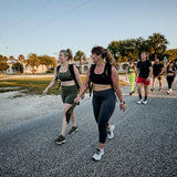 Women wearing GORUCK rucking gear and charcoal cropped leggings walking outdoors in a group